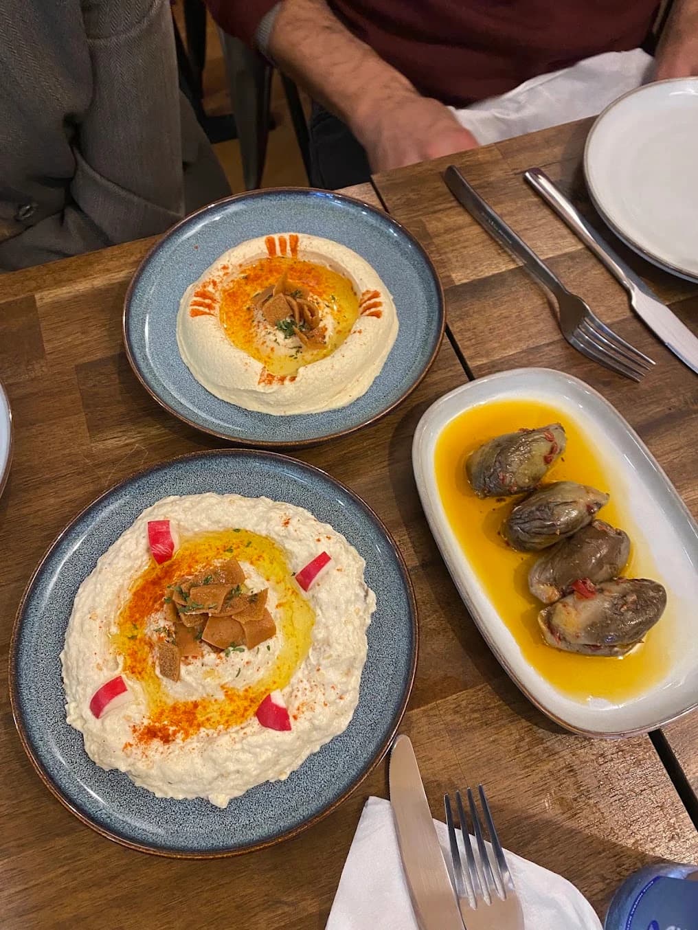 Hummus, aubergine dip and stuffed aubergines shared at a Layali Beirut table